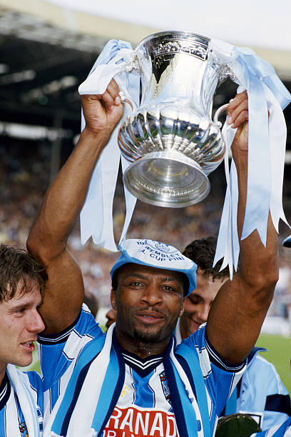 coventry-city-player-cyrille-regis-lifts-the-fa-cup-after-the-final-picture-id453165702